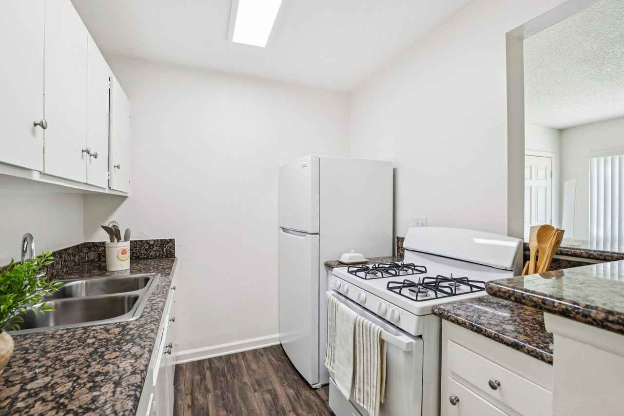 Dresden Place Apartments modern galley kitchen with quartz countertops